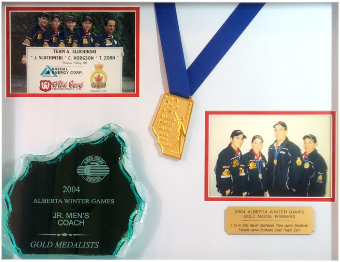 Upper Left is picture of Team Sluchinski standing behind large sign recognizing all their sponsors, Then there is the Team Alberta Gold Medal, lower left hand size is their Glass Award of the Gold Medal Winners, on the middle right hand side of the frame is a picture of the team with an engraved plate below with their names.